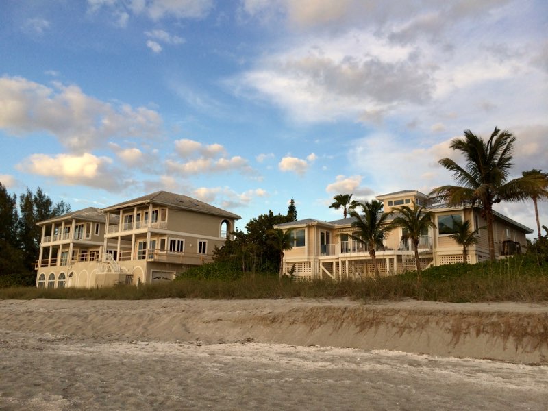 Exterior Photo of a White Beach House from the sand